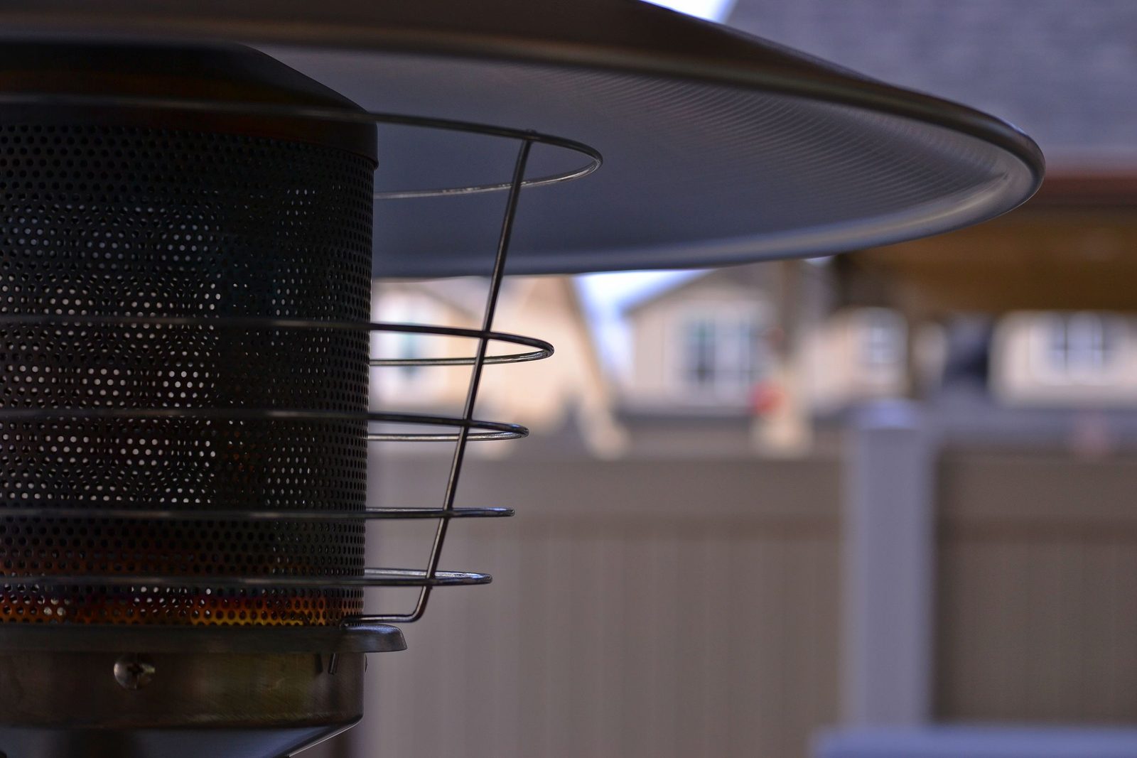 Pilot Light Heating. Close on a dark heater grille.