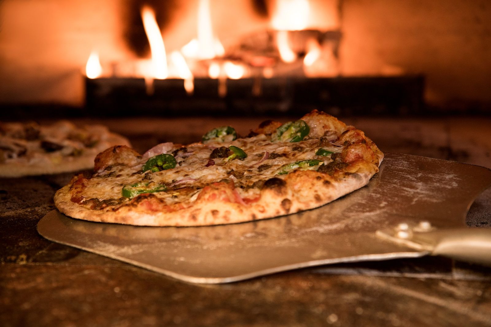A pizza on a peel, just out. Coal Door.