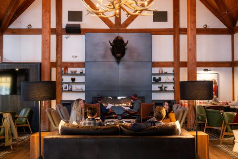 Option D thumbnail: guests relaxed by lodge fireplace