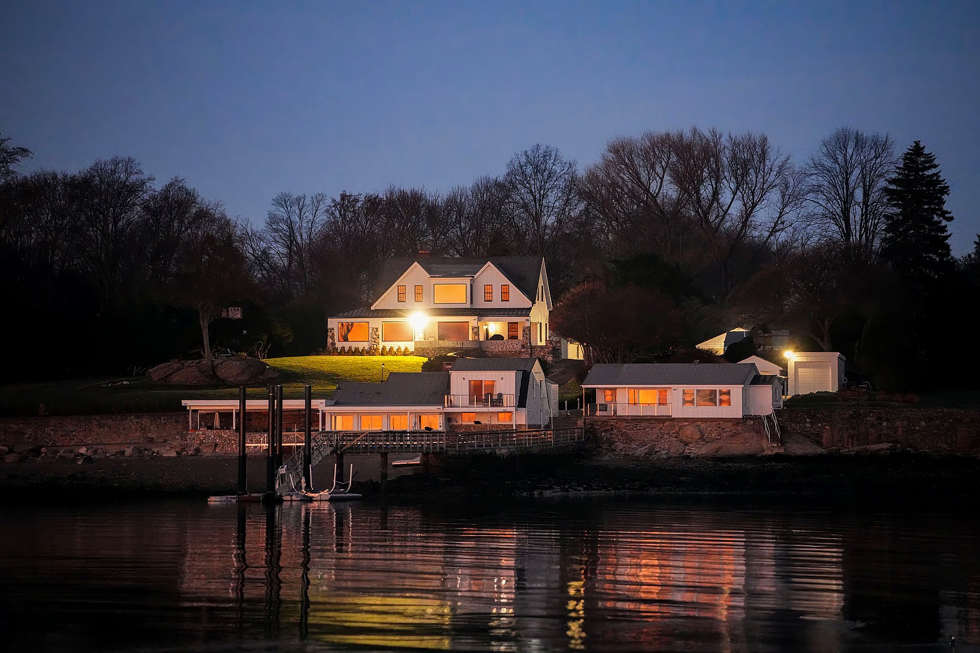 Lake Beam Builders. Timber frame rising over a Maine lake.