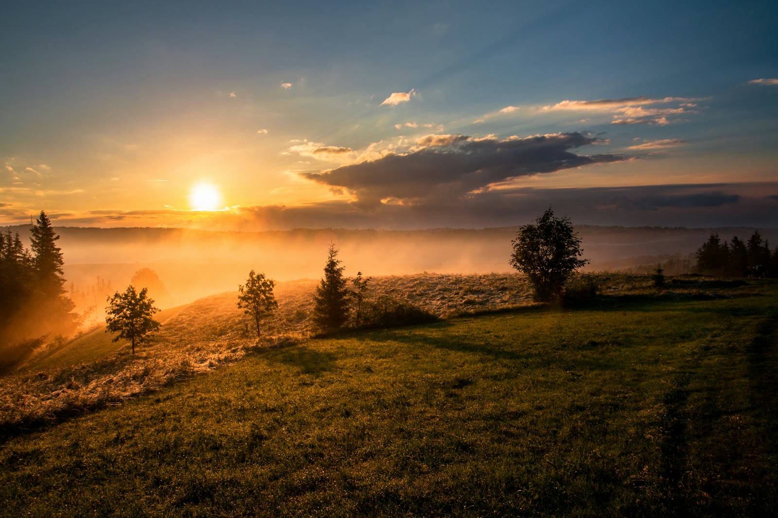 Warm evening light over a mountain landscape.